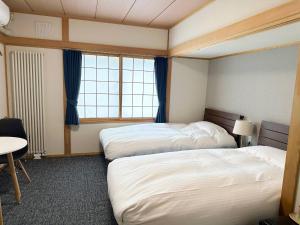a hotel room with two beds and a window at RONENAI BASE - Vacation STAY 87314v in Shibinai +14 photos