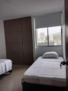 Ένα ή περισσότερα κρεβάτια σε δωμάτιο στο Apartamento en ARAGOA , rodadero sur