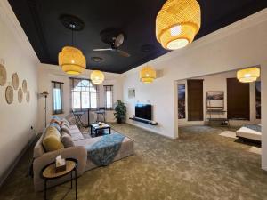 a living room with a couch and a tv at Oman beach house in Muscat