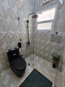 a bathroom with a shower with a toilet and a window at Oman beach house in Muscat +18 photos