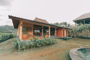 a house with a swimming pool in front of it at Tebola Villa Resort in Sidemen