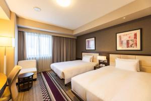 Postel nebo postele na pokoji v ubytování Hotel Sunroute Plaza Shinjuku