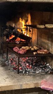 a fire oven with food cooking in it at Casa da Praia in São José do Norte