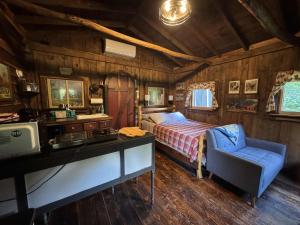 a bedroom with a bed and a desk in a room at The Renovated Barn at Seneca Rocks in Seneca Rocks