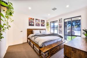 a bedroom with a bed and a large window at King Suite with Private Ensuite in Perth