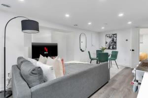 a living room with a couch and a dining room at Modern 1-BR Condo with Parking in Downtown Toronto in Toronto