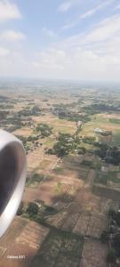 an aerial view of a field from an airplane at Kmp in Mau