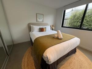 a bedroom with two beds and a window at Haehaenui Retreat - with Stoked hot tub in Arrowtown