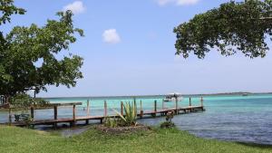 a row of wooden docks in the water at HOKAB in Cenote Azul
