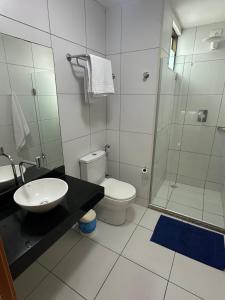 a bathroom with a sink and a toilet and a shower at Apartamento na Barra de São Miguel in Barra de São Miguel