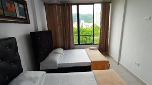 Ένα ή περισσότερα κρεβάτια σε δωμάτιο στο Apartamento Paraiso Family