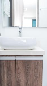 a bathroom sink with a mirror on top of it at Apartahotel Ginebra central cerca laureles in Medellín +27 photos