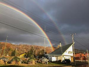 a rainbow in the sky over a church with a house at RONENAI BASE - Vacation STAY 87889v in Shibinai