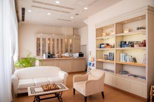 a living room with a white chair and a table at Luke Plaza Hotel in Nagasaki