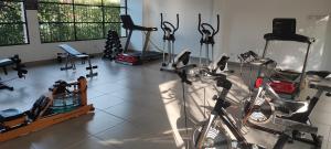 a gym with a bike and some exercise equipment at Departamento Completo Hacienda Peñalisa - Ricaurte in Ricaurte