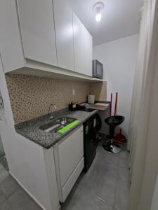 a kitchen with a sink and a counter top at Studio Teresa - 200m UFSJ e Igreja São Francisco in São João del Rei +3 photos