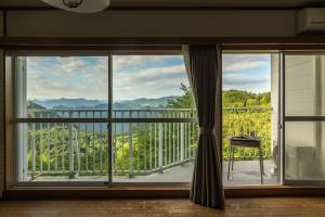 a large window with a view of a mountain view at 軽井沢 デッキからの眺望 BBq カラオケ IC下車5分 in Karuizawa