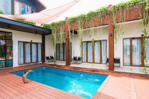 a swimming pool in front of a house at Chrisenbel Hideaway Retreat in Petaling Jaya