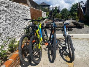 two bikes are parked next to a wall at The hills in Pokhara