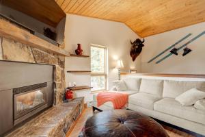 a living room with a couch and a fireplace at 382 Sunburst in Big Sky