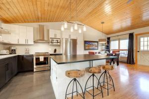 a kitchen with a large island with bar stools at 382 Sunburst in Big Sky