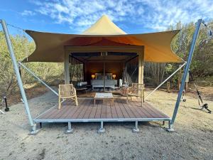 a gazebo with two chairs and a table and a table at Ukiyo Nature Retreat in Fingal
