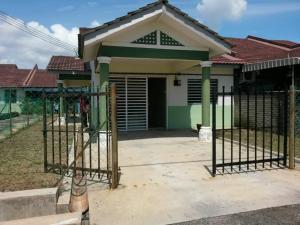 a house with a gate in front of it at Irah Homestay in Kuantan