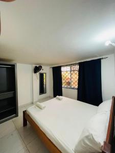 a bedroom with a large bed and a window at 2 bedroom Duplex at Kisimani Heights Apartments, Nyali, Mombasa in Mombasa