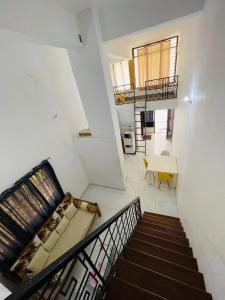 a staircase with a couch and a table in a room at 2 bedroom Duplex at Kisimani Heights Apartments, Nyali, Mombasa in Mombasa