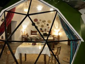 a room with a table in a tent at The Tortoise Dome Lodge in Bellavista