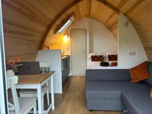 a room with a couch and a table with a laptop at The Dales Gateway Retreat in Gargrave +13 photos
