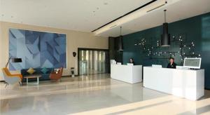 a lobby with two people sitting at reception desks at Echarm Hotel Chengdu Pidu Comprehensive Bonded Zone BOE in Chengdu