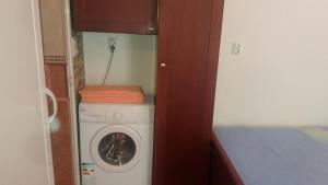 a washer and dryer in a small room at Apartments Mira in Tivat