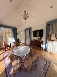 a living room with a table and a couch at Villa de Jano in Ban Muang Pha +8 photos