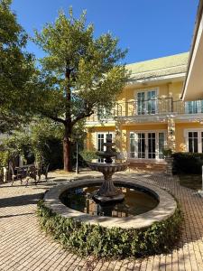 a fountain in the courtyard of a building at Villa de Jano in Ban Muang Pha