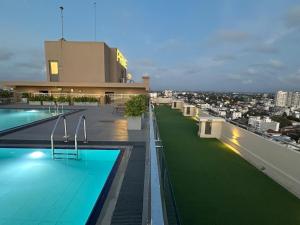 a swimming pool on the roof of a building at 43 By The Sea in Dehiwala +18 photos