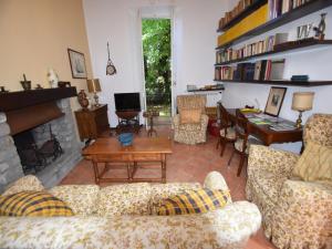 a living room with couches and a fireplace at Belle Epoque Belvilla by OYO in Meina