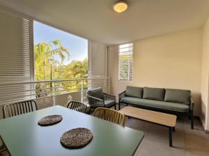 ein Wohnzimmer mit Sofa und Tisch in der Unterkunft Appartement Club Ocean in L'Ermitage-Les-Bains