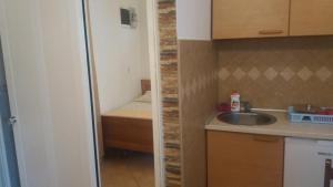 a small kitchen with a sink and a shower at Apartments Mira in Tivat +29 photos
