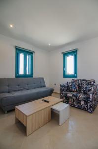 a living room with a couch and a coffee table at Ios Sea View in Ios Chora