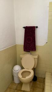a bathroom with a toilet and a red towel at Guest Studio near Businesses and Markets in Ensenada +15 photos