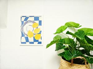 a plant in a basket next to a picture at MINI HOUSE Gwangan Beach #closest to the beach #drone show #cozy in Kwangan-dong
