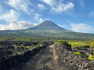 a mountain in the distance with a dirt road in front at Casa Fitz - Bungalow with Ocean Views and Air Conditioning in Santa Luzia