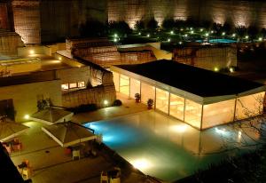 an overhead view of a swimming pool at night at Cave Bianche Hotel in Favignana