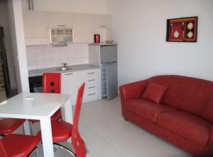 a living room with a red couch and a table at Villa Apartments Kumbor President in Kumbor