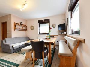 a living room with a table and a couch at Holiday Apartment Vuković in Saborsko