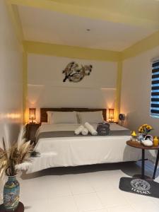 a bedroom with a bed with two towels on it at Cashew Blossom Boutique Guest Home in El Nido