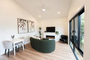 a living room with a couch and a table at Moritz Hahndorf Boutique Guest House in Hahndorf