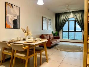 a living room with a table and a couch at Hush Inn at K Avenue Kota Kinabalu in Kota Kinabalu