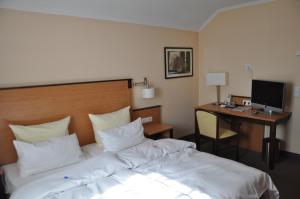 Postel nebo postele na pokoji v ubytování Hotel Gasthof Vogelsang